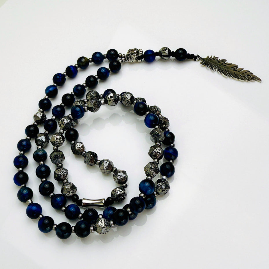 Handgefertigte Lapislazuli-Lavastein-Herren-Halskette mit Edelstahl-Federn-Anhänger. Kombination aus tiefblauem Lapislazuli, silbernen Lavasteinen und elegantem Design – ein Statement für Stärke und Freiheit.