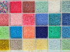 Kleine bunte Glasperlen (Roccailles), in 24 Fächerboxen hübsch dargestellt.