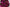 Runde, glänzende Tigerauge-Perlen in kräftigem Pink bis Magenta, stilvoll arrangiert in einer Schale.