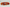 Handgefertigtes Armband mit leuchtenden Karneol-Quarz-Perlen in Orange-Rot, verziert mit eleganten Edelstahl-Elementen und funkelnden schwarzen Kristallakzenten. Ein modernes Accessoire mit lebendigen Farben und hochwertiger Verarbeitung.